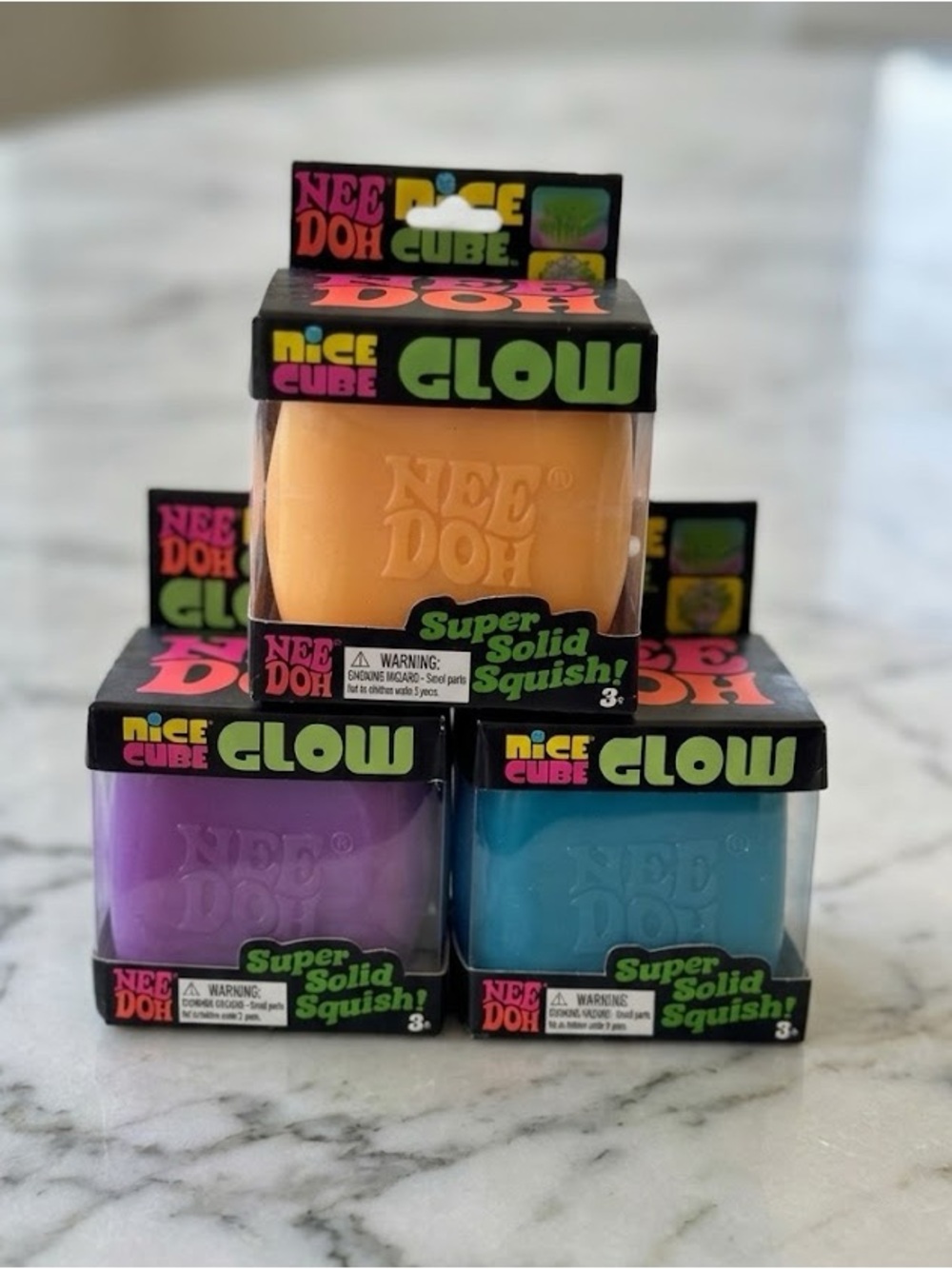 NeeDoh Nice Cube Glow Super Solid Squish - Orange, Purple, Blue
